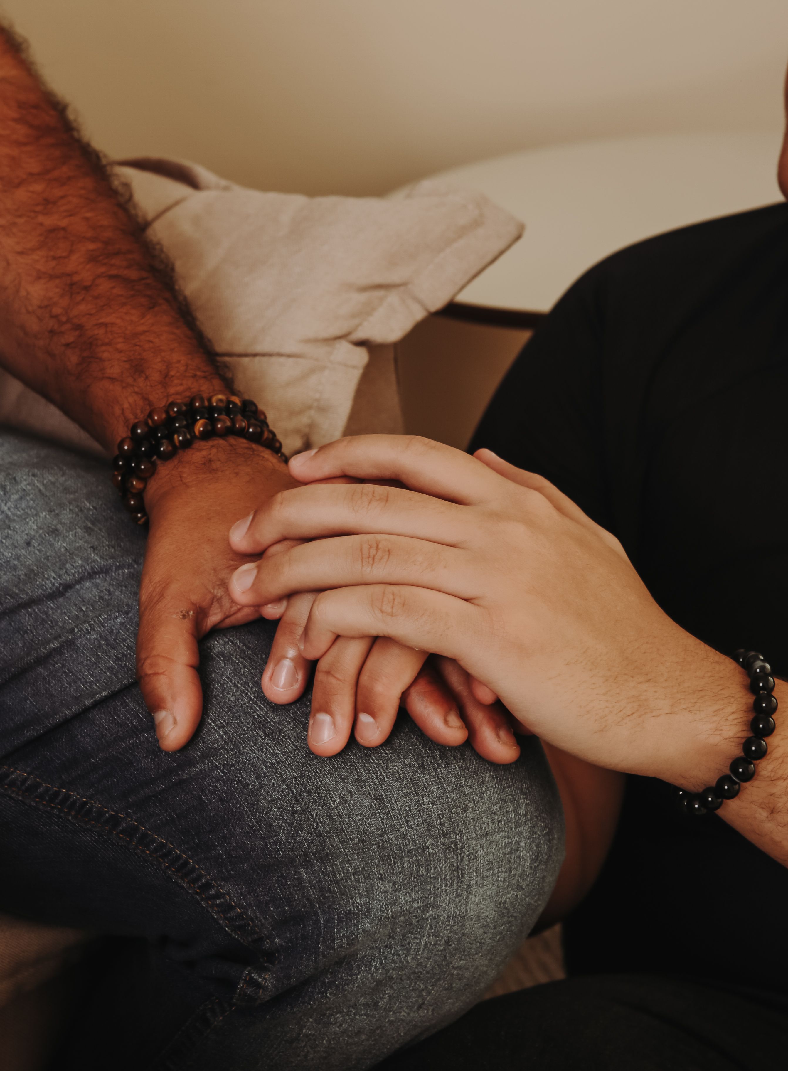 Two people's hands resting together in support