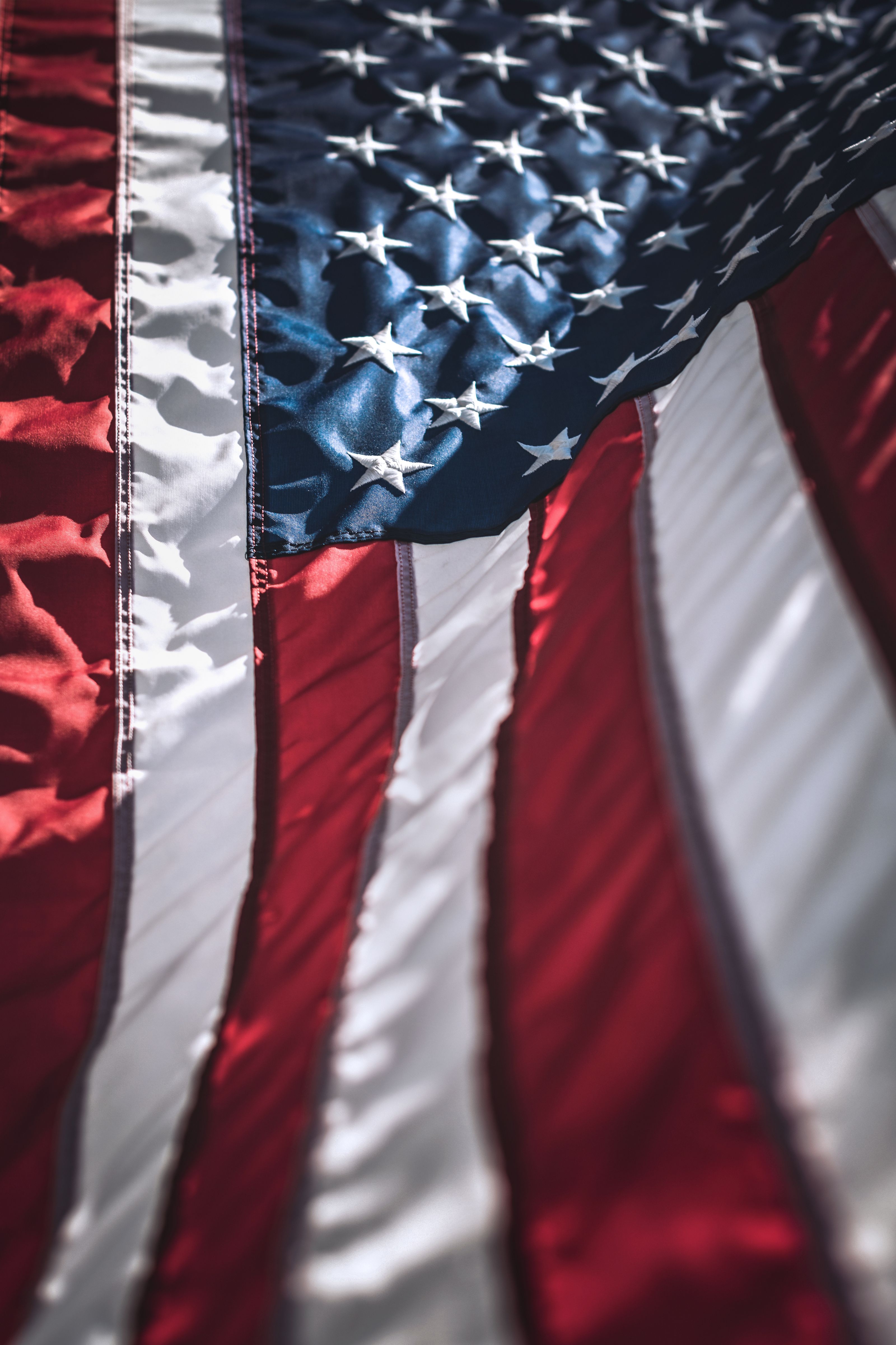 An American flag backlit by sunlight