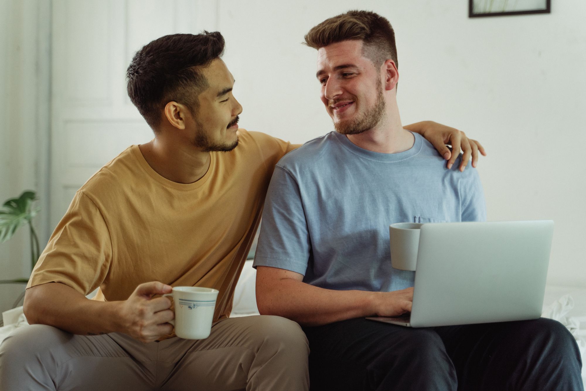 One person resting a supportive arm around another at home